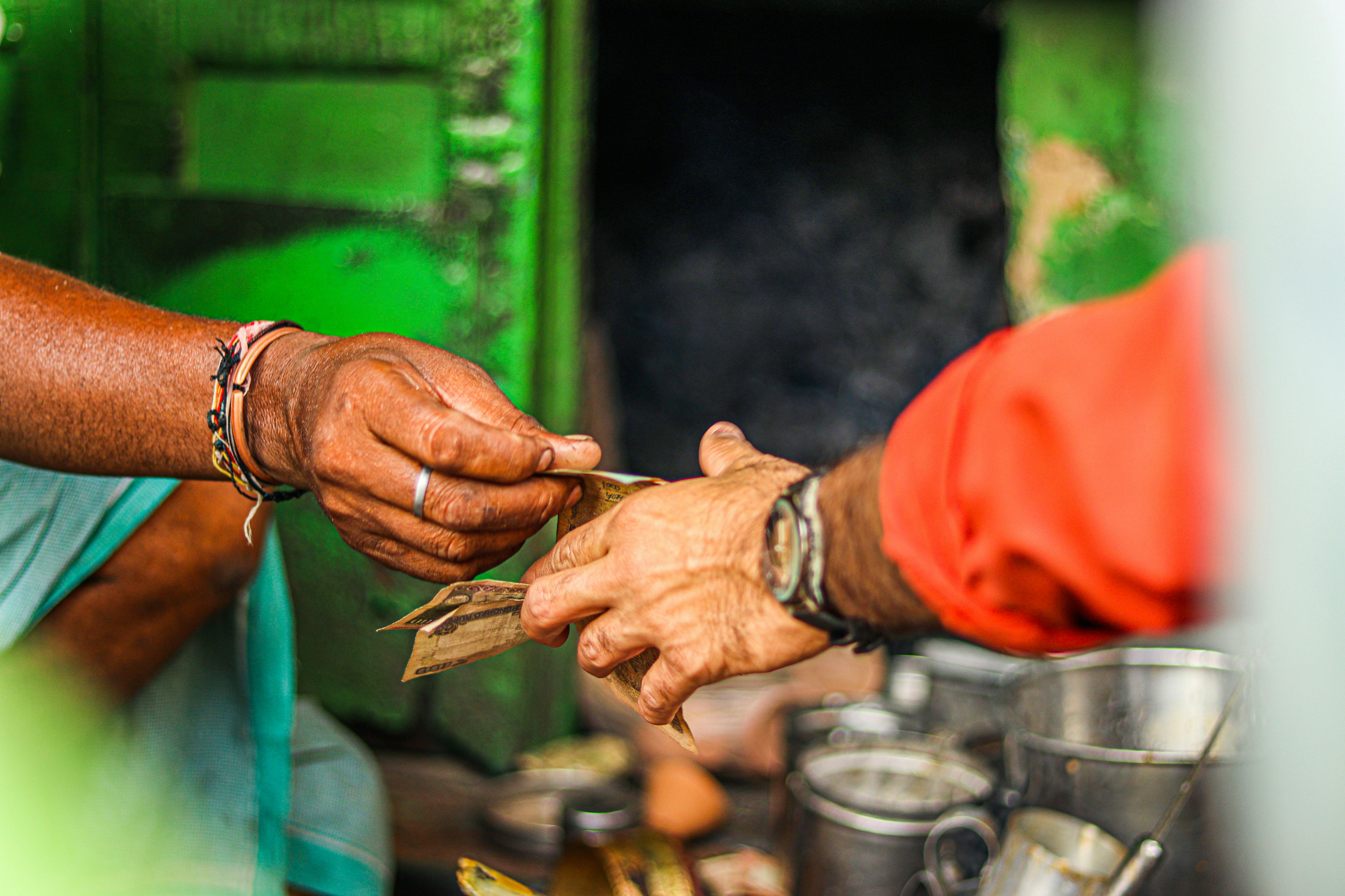 Cash transaction at local shop - Photo by Swastik Arora