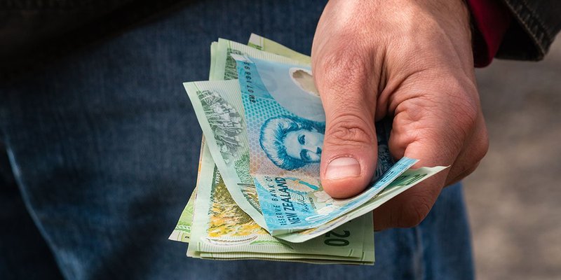 New-Zealand-dollars-hand-WIDE-shutterstock-262514741.jpg