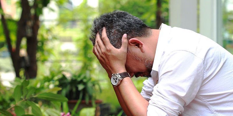 Asian man stressed wide