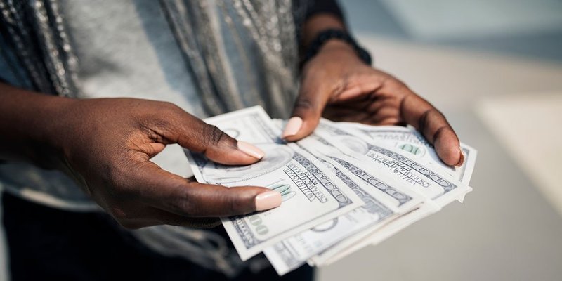 hands-100-dollars-WIDE-shutterstock-1069879709.jpg