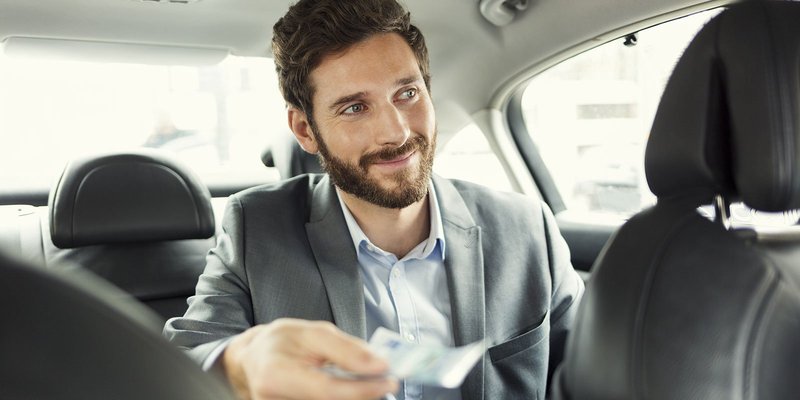 man-paying-cab-HEADER-shutterstock_265927553.original