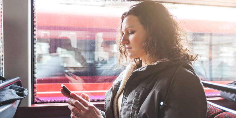 woman-bus-phone-HEADER-shutterstock_268614653_V.original